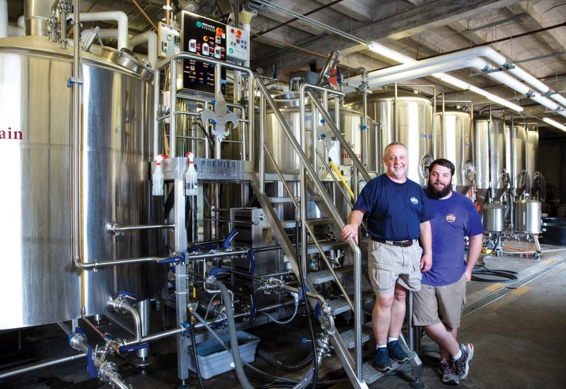 Father-son team Tom, left, and Alex Daigrepont in the Tin Roof brewhouse.